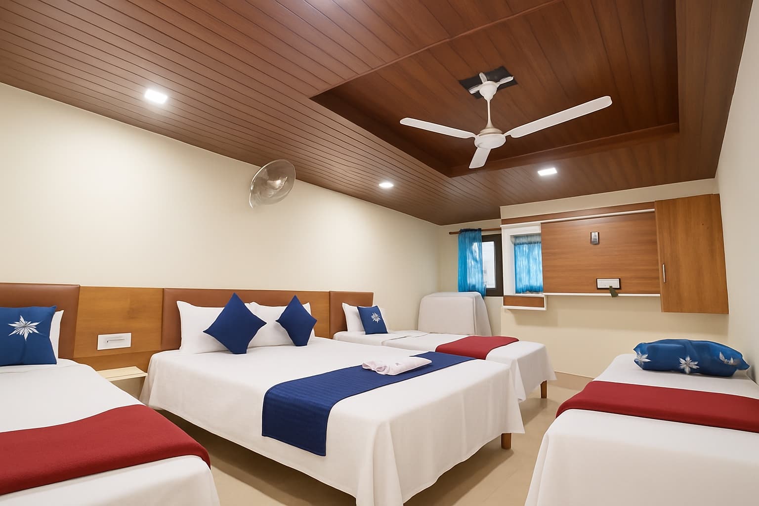 Family Room — one queen bed and two twin beds under a wood-panel ceiling